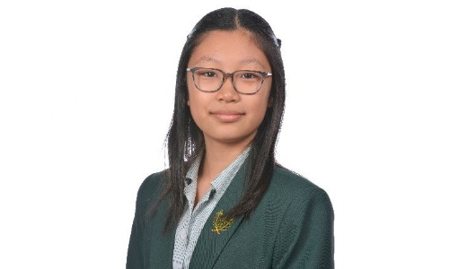 Pupil in green school uniform.