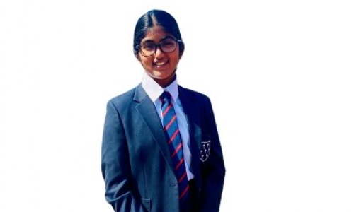 Pupil in a navy blue school uniform